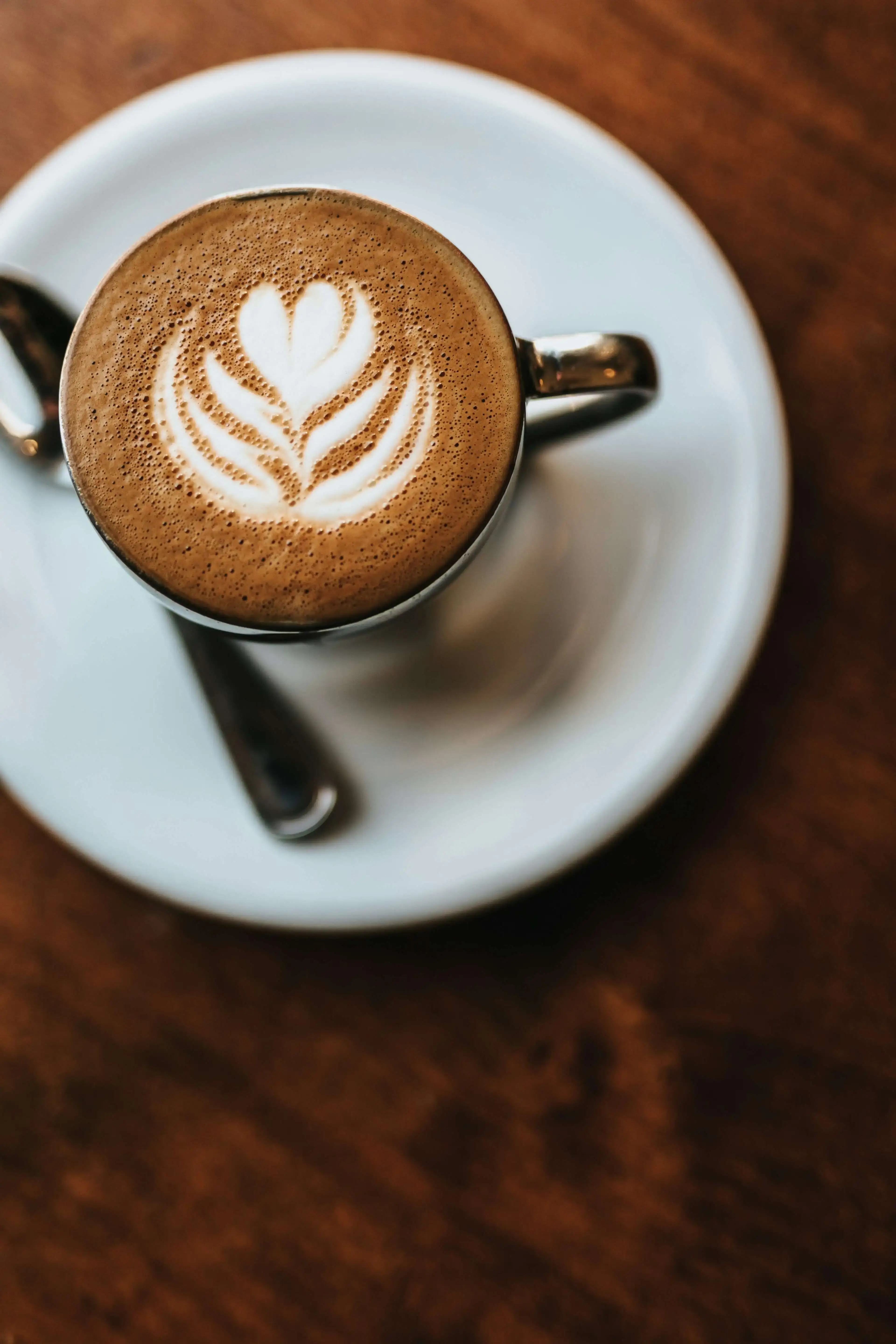 Freshly brewed latte with beautiful latte art, served in a white ceramic cup